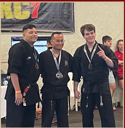 Team Ascension martial artists celebrating competition medals